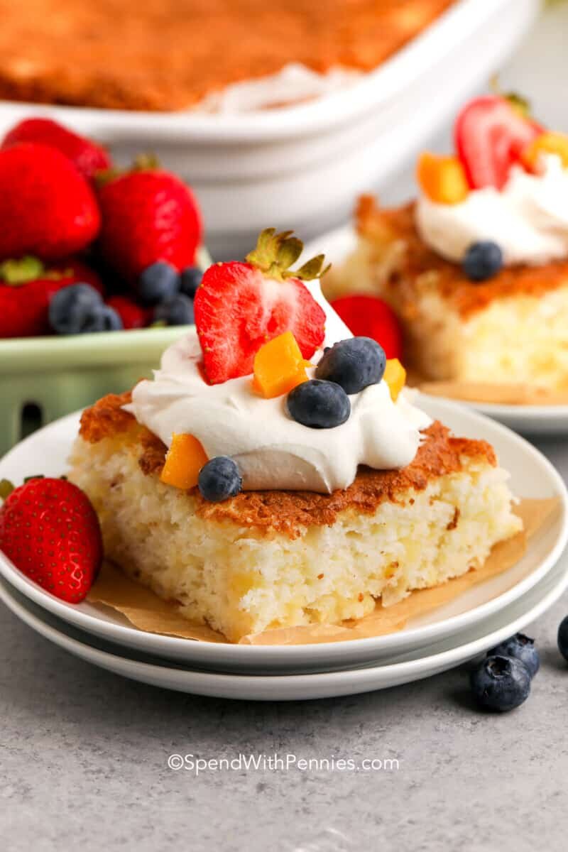 a slice of pineapple angel food cake with whipped topping on a plate