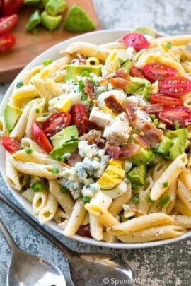 Overhead shot of Cobb Pasta Salad next to two silver spoons