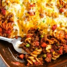 a casserole dish of baked hamburger casserole with a spoon