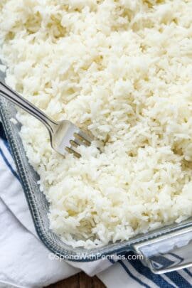 closeup of baked rice in a casserole dish with a fork