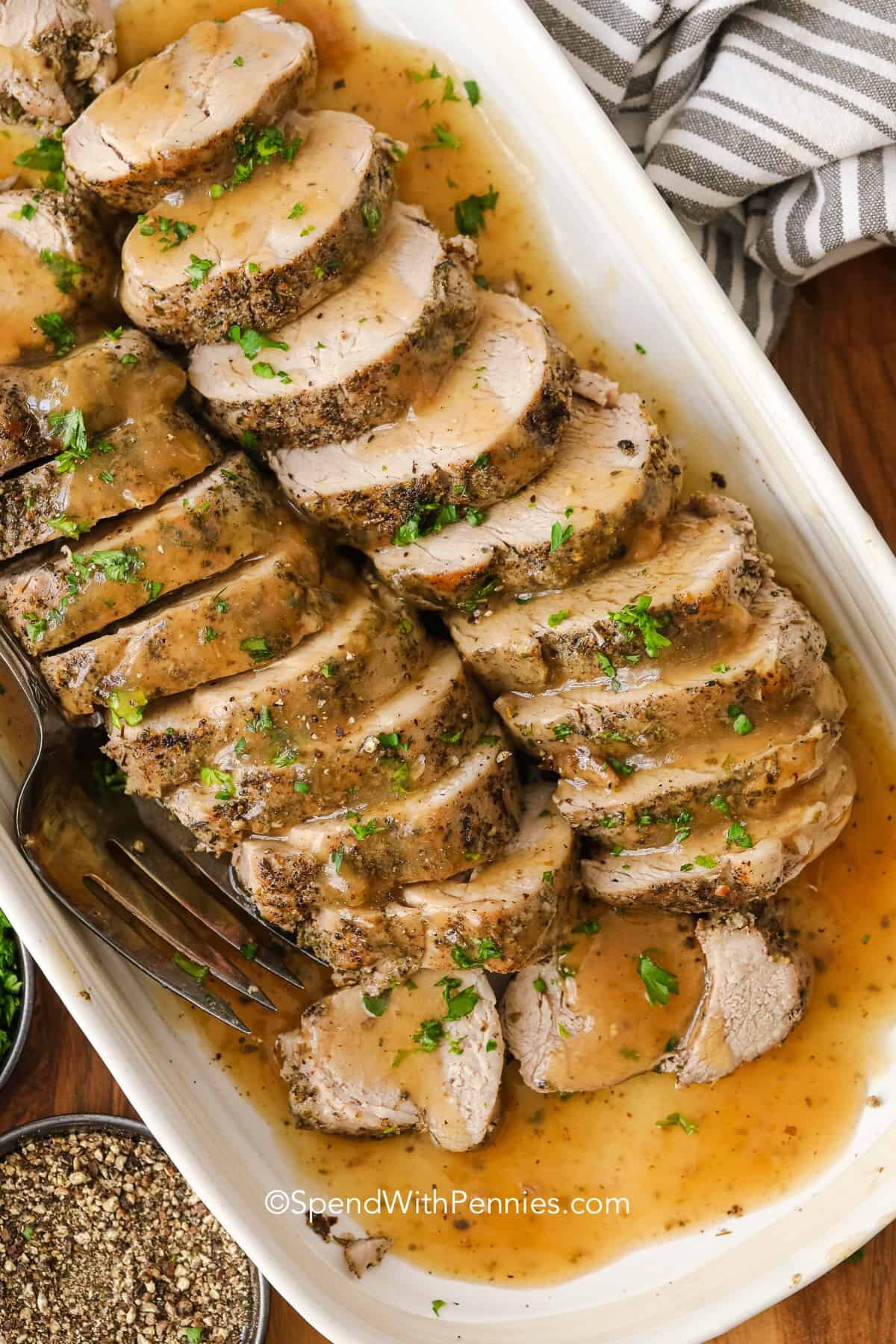 Pork tenderloin on a plate with gravy