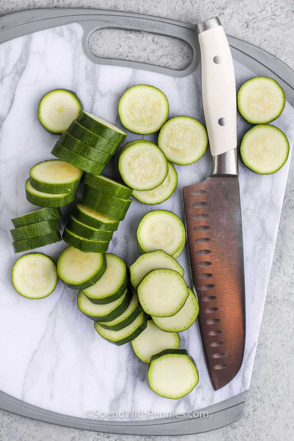 cutting slices of zucchini to make Sauteed Zucchini