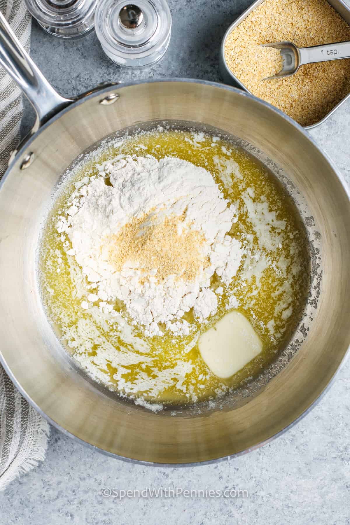 adding flour and seasonings to butter to make Baked Mac and Cheese